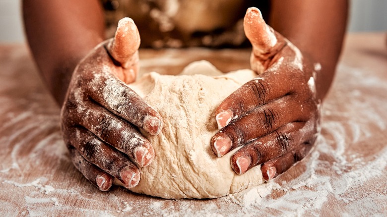 Hands kneading bread dough