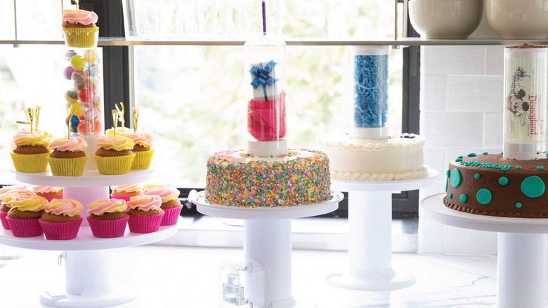 counter with several surprise cakes on stands