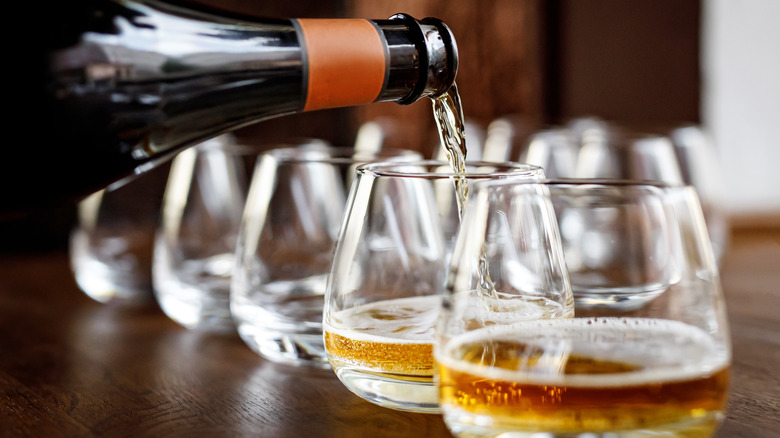 Glasses being filled with cider