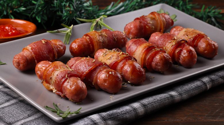 Traditional British rasher-wrapped sausages on plate