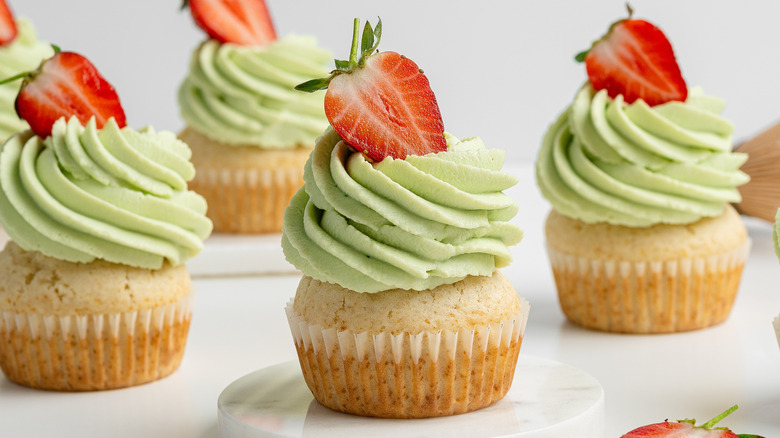 matcha buttercream mufins topped with strawberry
