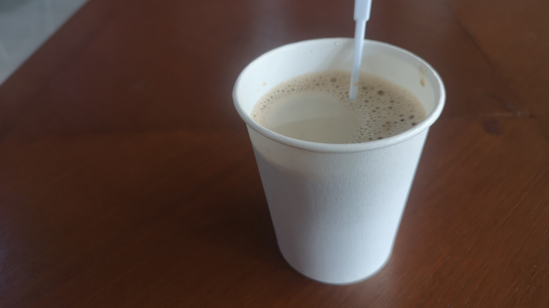 Light and sweet hot coffee in a paper cup