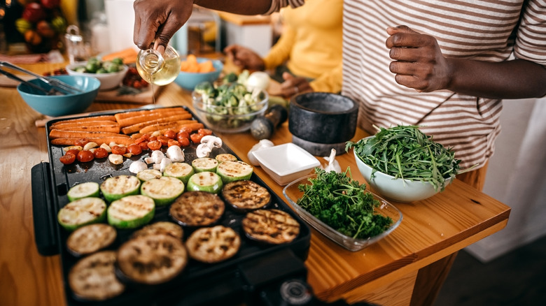 Preparing carrots, mushrooms, zucchini on an indoor grill