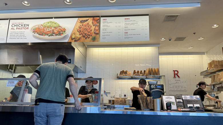 person ordering food at Chipotle counter