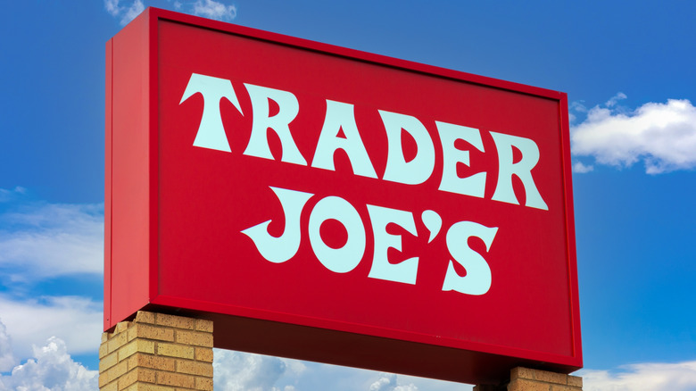 Trader Joe's sign with blue sky and clouds in the background