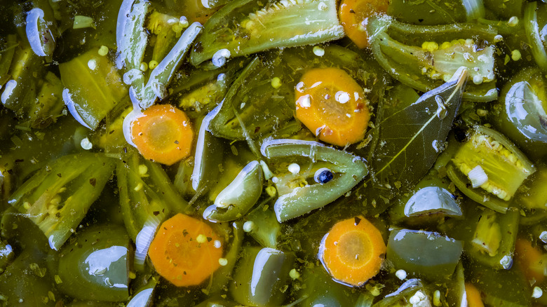 jalapeños and carrots floating in brine