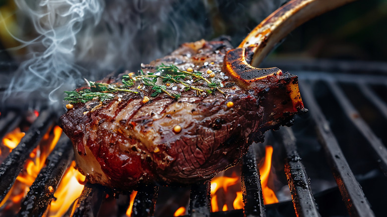 Seasoned steak on grill