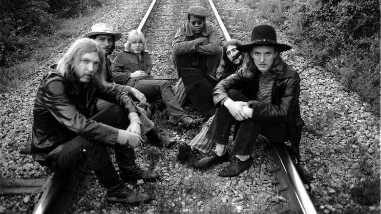 Allman Brothers sitting on railroad