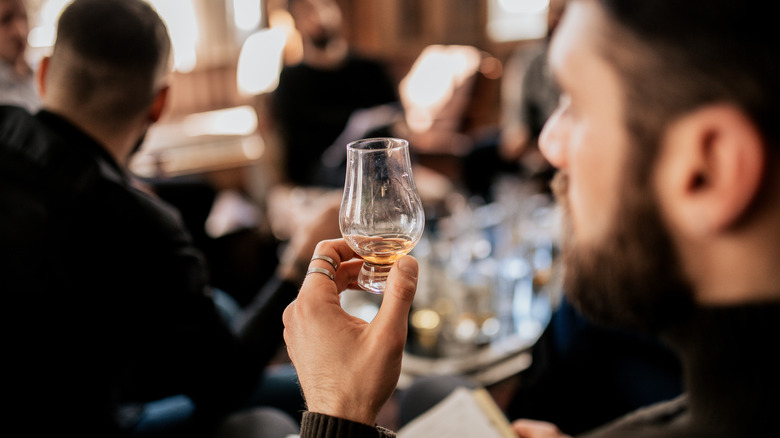 Man holding whisky snifter