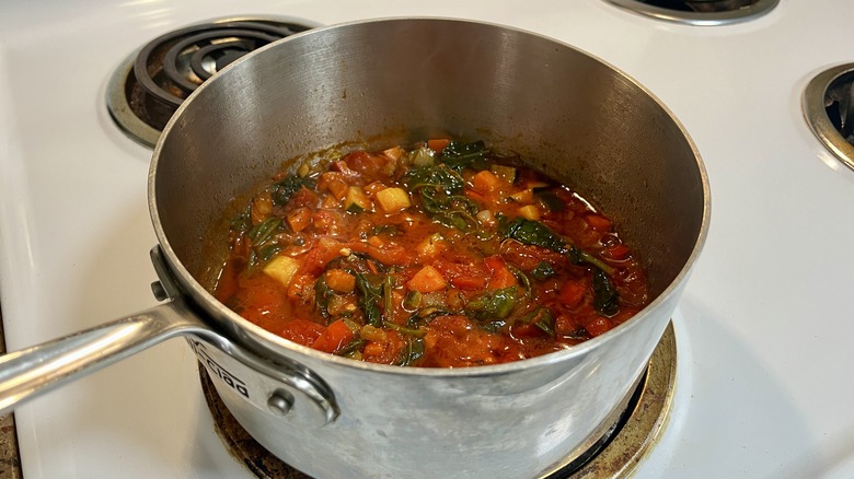 a pot with cooked tomatoes and vegetables