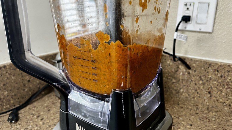 a blender with tomato sauce