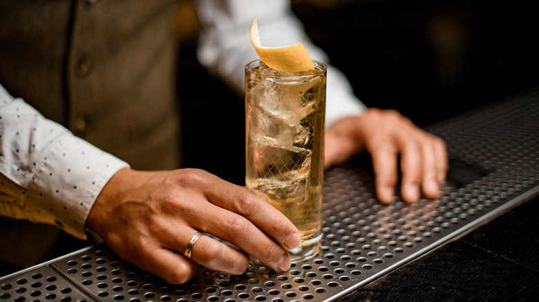 bartender offers whiskey highball 