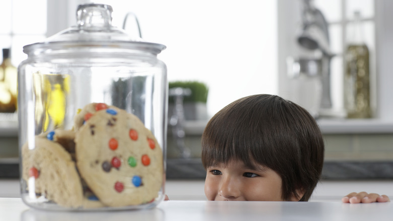 Child looking at cookie jar