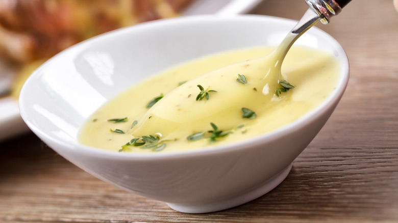 White dish of herby bearnaise sauce