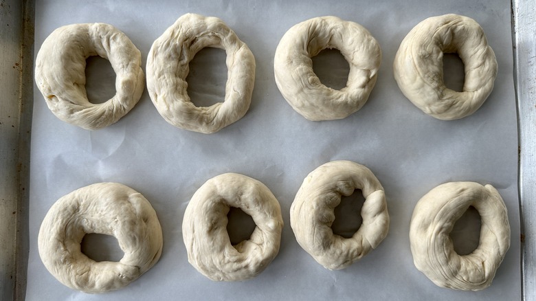 Bagel dough rings on baking sheet