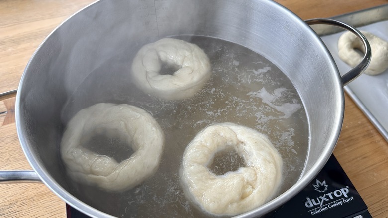 Bagels floating in baking soda bath