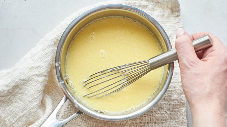 whisking milk and butter in a saucepan