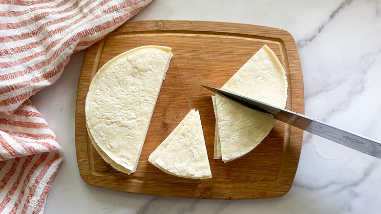 tortillas on board being cut