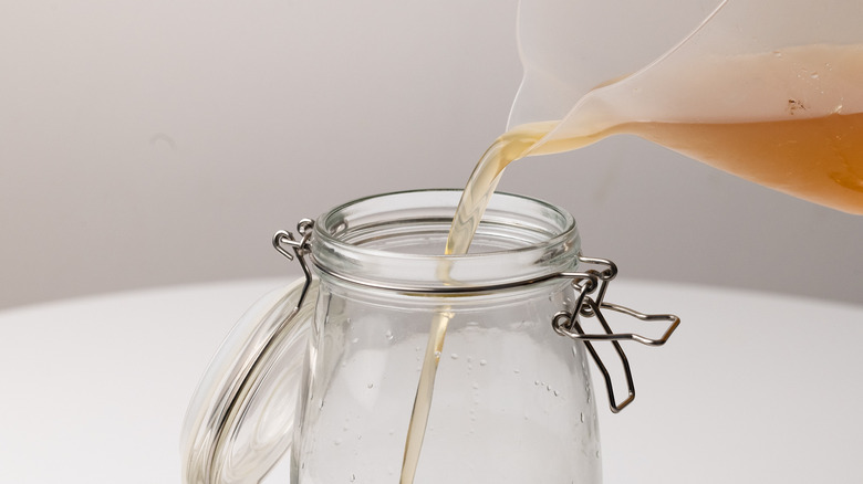 Pouring syrup into liqueur infusion 