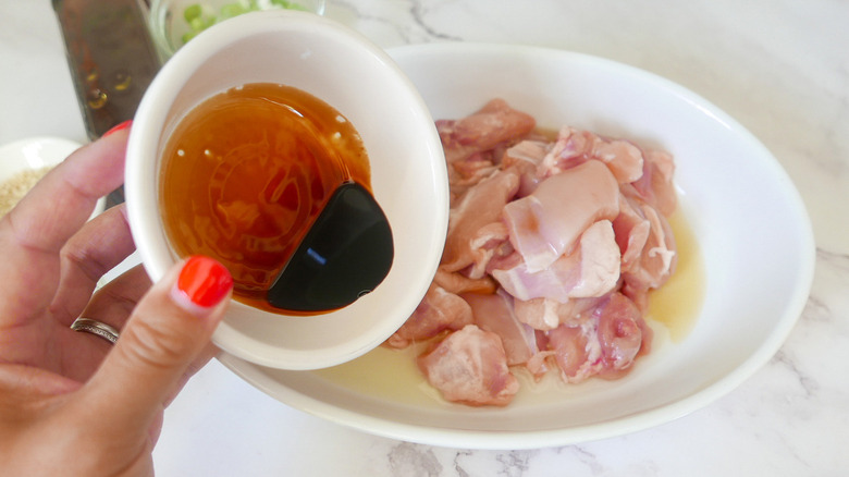 pouring sauces onto chicken