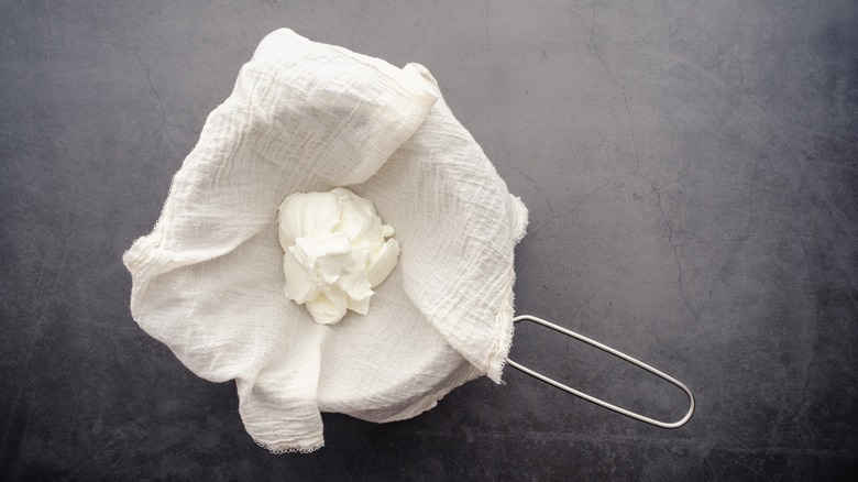 Straining labneh in cheesecloth