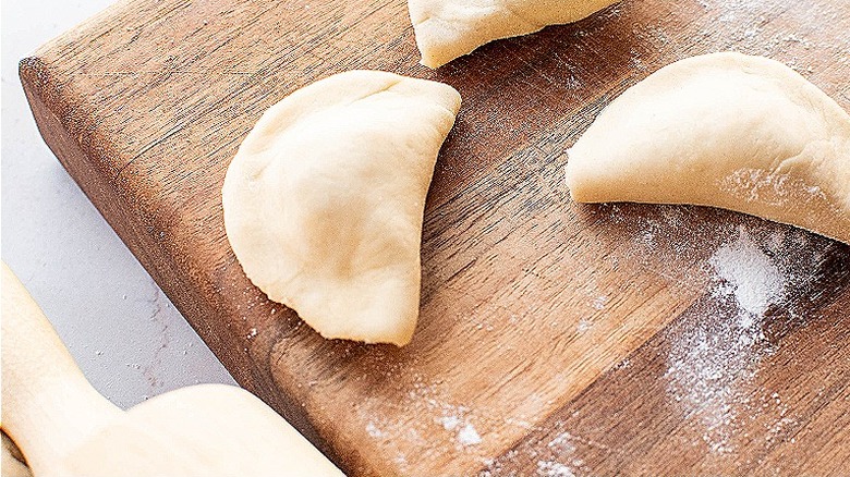 raw pierogi on table