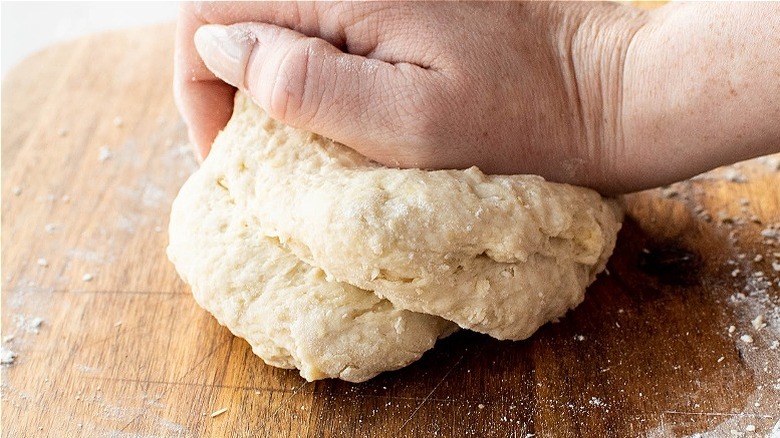 kneading dough on floured surface
