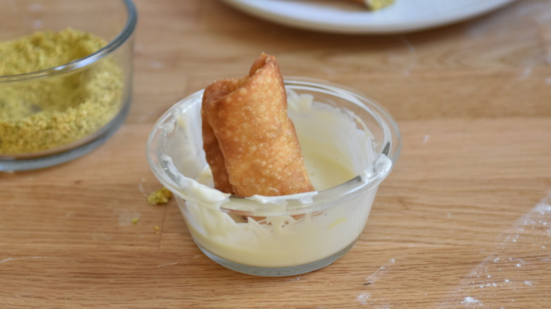 dipping cannoli in white chocolate