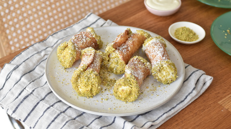 pistachio cannoli with powdered sugar