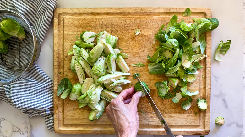 cutting board with cut brussels sprouts