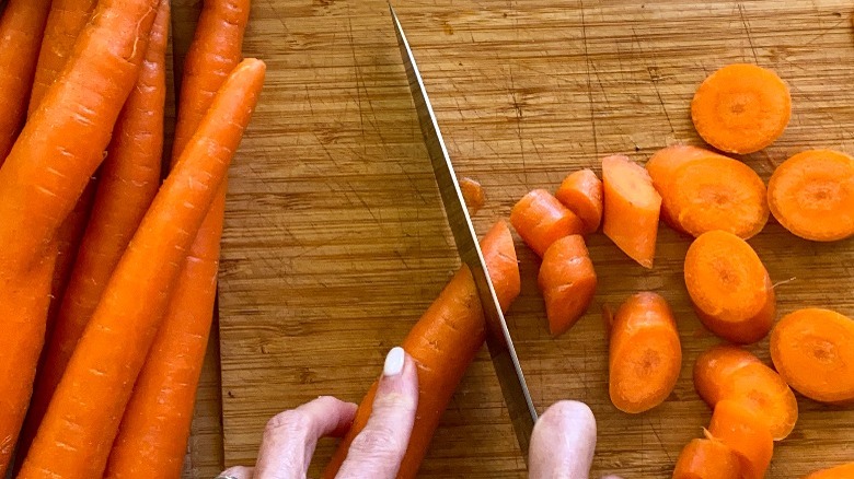 cutting carrots on board