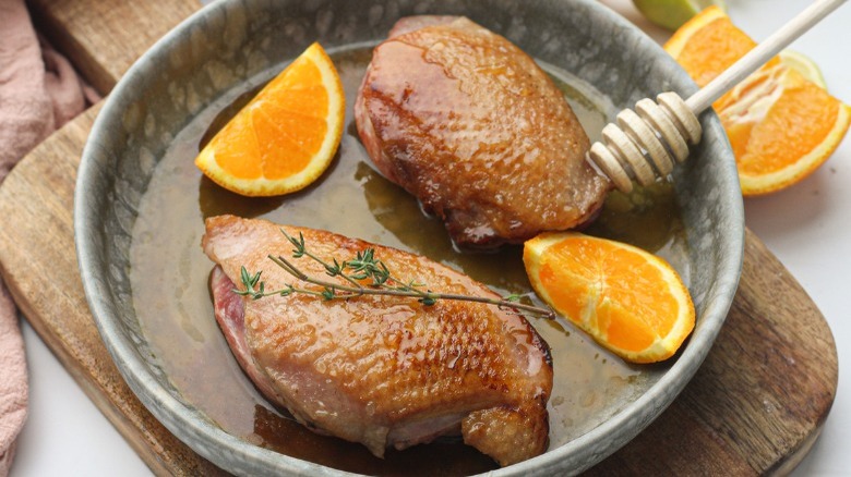 seared duck breasts with orange wedges