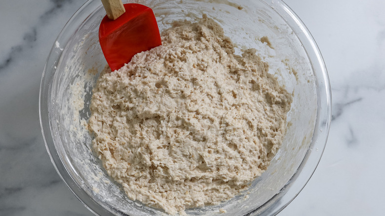 bread dough in clear bowl