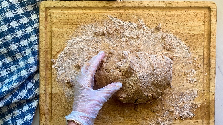 kneading the dough on board 