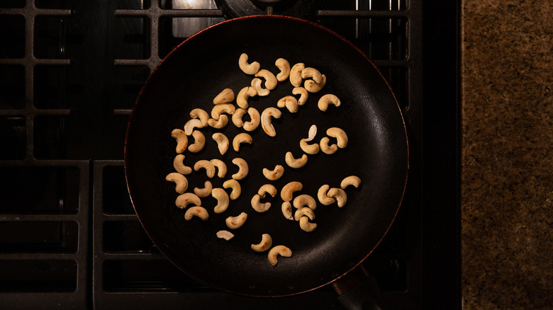 cashews toasting in frying pan 