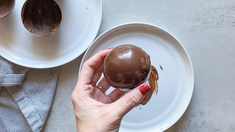 hand holding hot chocolate bomb