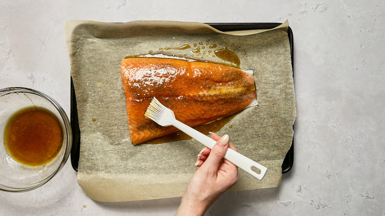 brushing glaze onto salmon