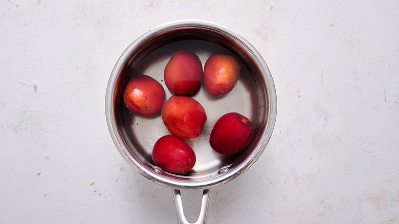 apricots covered in water in saucepan