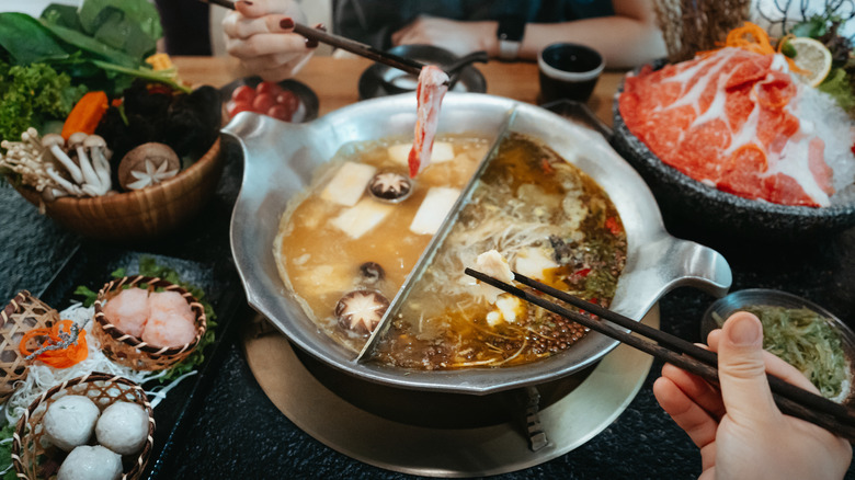 Foodies having hot pot in restaurant