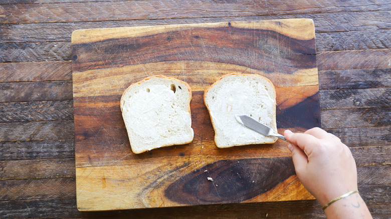 Spreading mayo on sliced bread