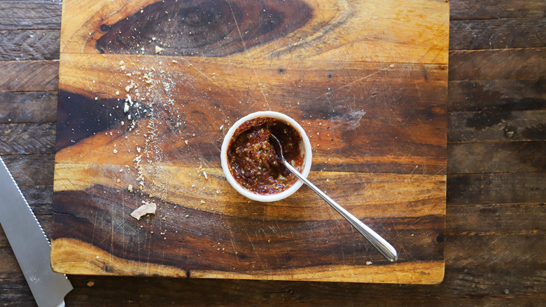 Bowl of cranberry mostarda on wood surface