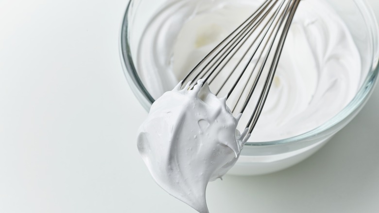 bowl of whipped cream with whisk