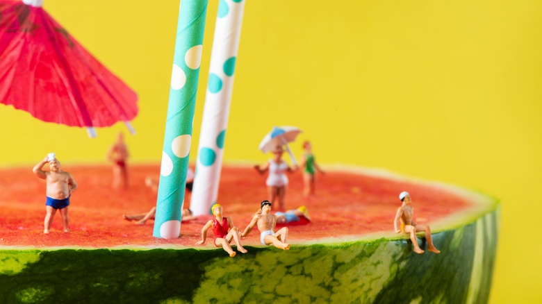 Paper straws in giant watermelon 