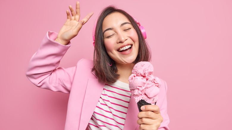 woman eating ice cream wearing headphones