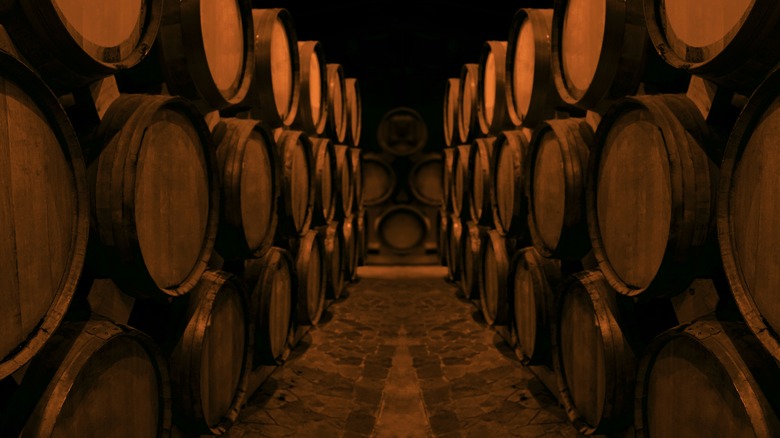 wooden beer casks stacked in cellar