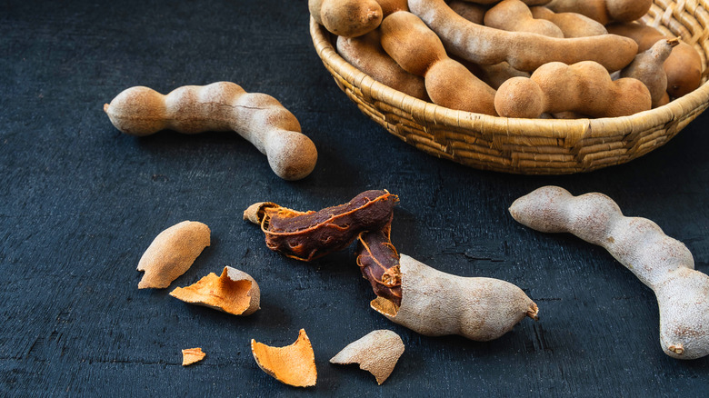 Bowl of tamarind on blue surface