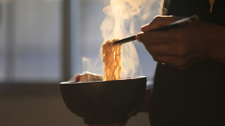 Person with instant ramen bowl