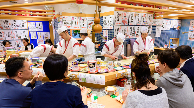 Diners eat at a kaitenzushi