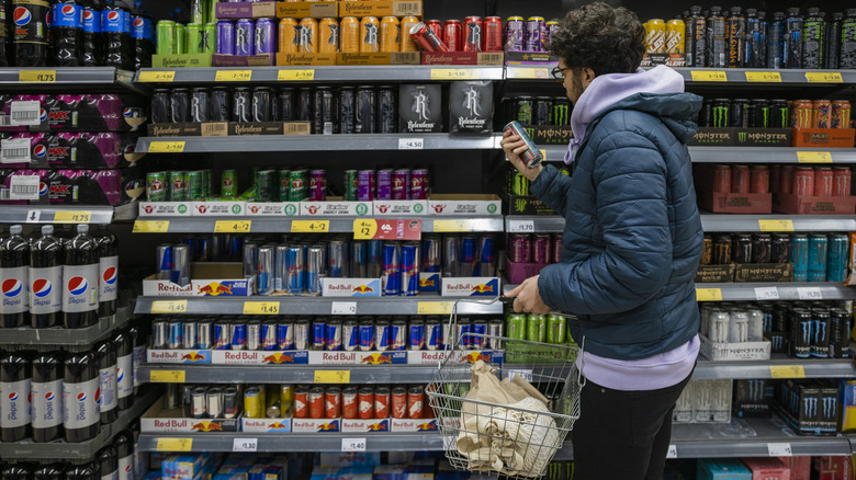 man shopping energy drinks