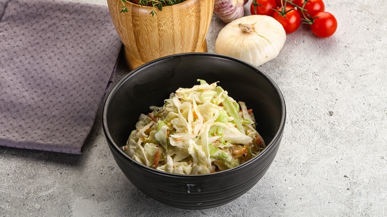 Bowl of coleslaw with garlic, tomatoes